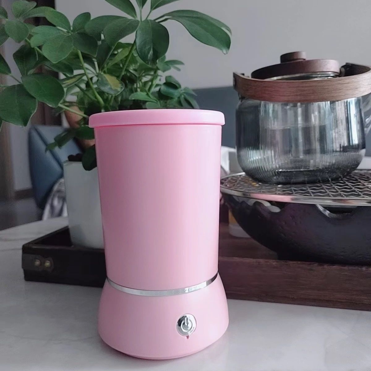 Pink dog paw cleaner on a kitchen counter.