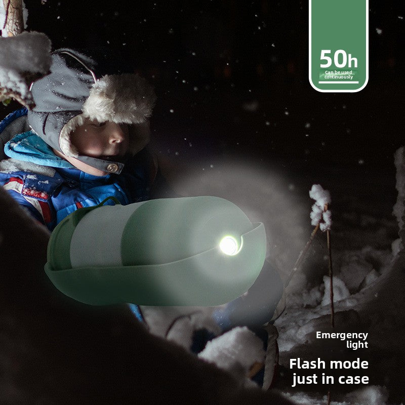 Child in winter clothing holding a folding dog water cup with LED light